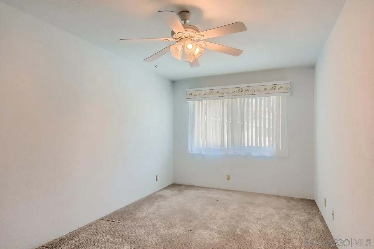 396 El Monte Road El Cajon, CA 92020 - Photo 14 of 18 an empty room with a window and a fan