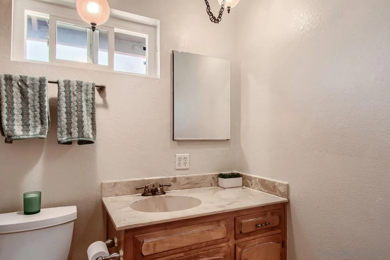 396 El Monte Road El Cajon, CA 92020 - Photo 16 of 18 a bathroom with a sink vanity and toilet
