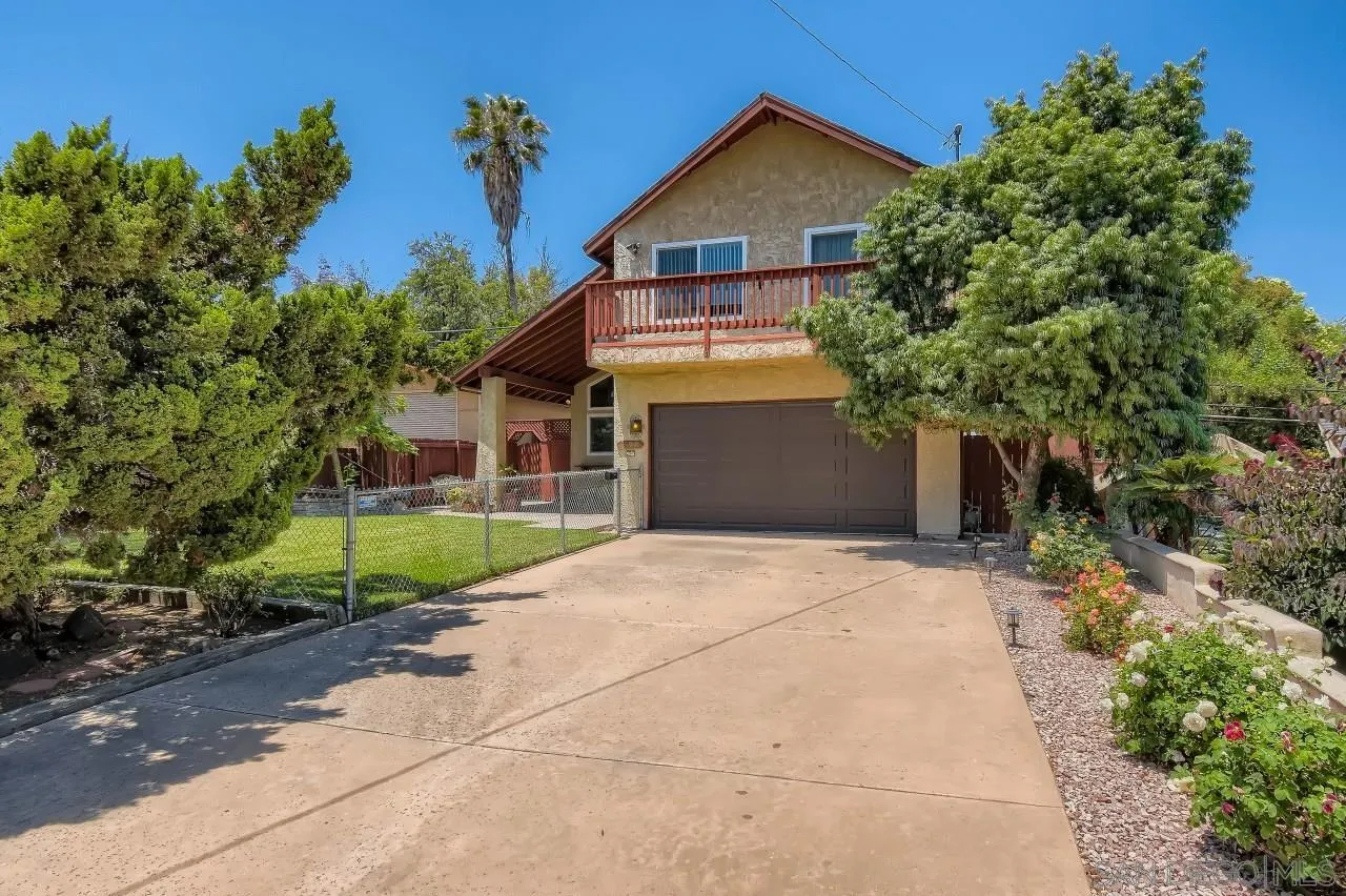 396 El Monte Road El Cajon, CA 92020 - Photo 2 of 18 a front view of a house with a yard and trees