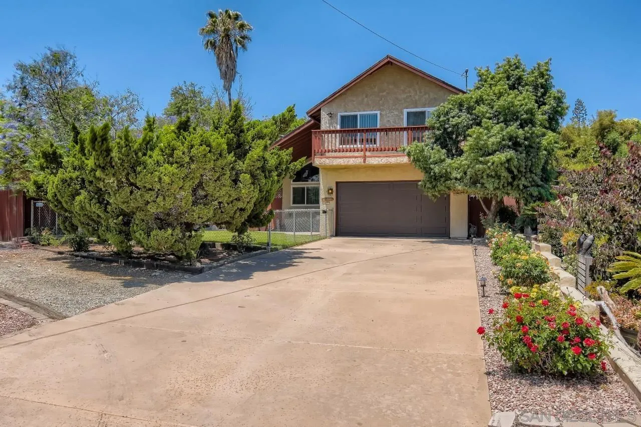 396 El Monte Road El Cajon, CA 92020 - Photo 3 of 18 a front view of a house with a yard and garage