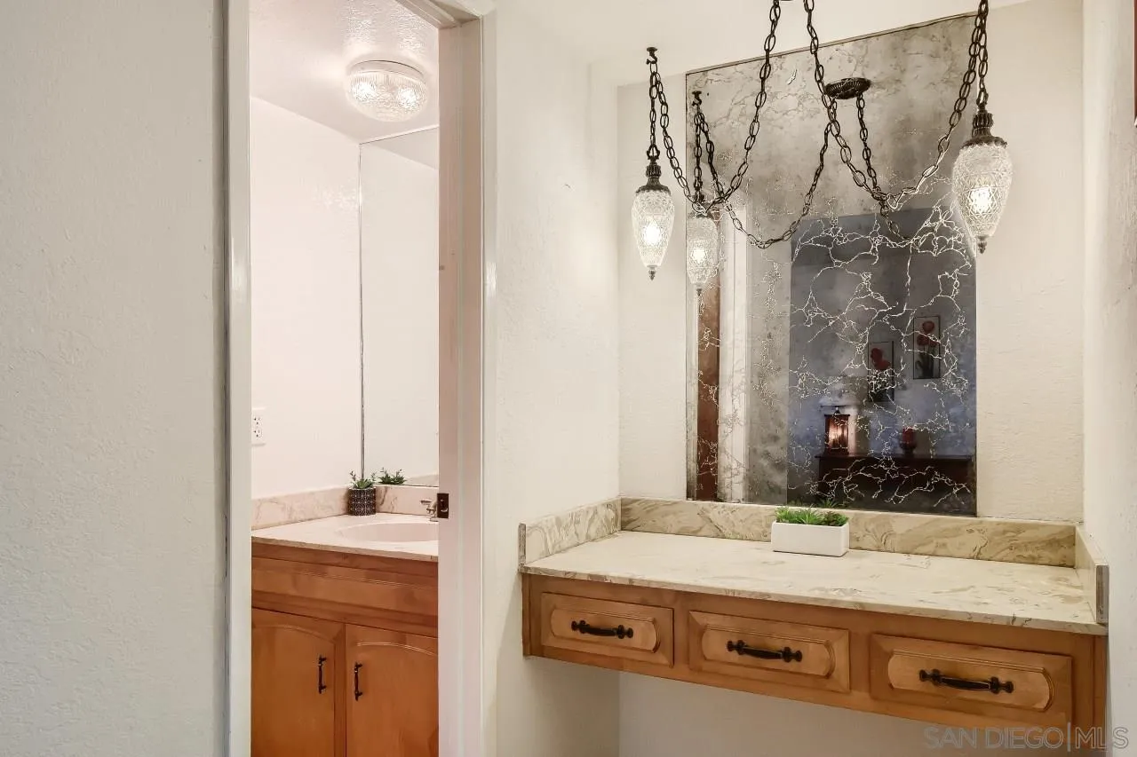 396 El Monte Road El Cajon, CA 92020 - Photo 9 of 18 a bathroom with a sink a mirror and a shower