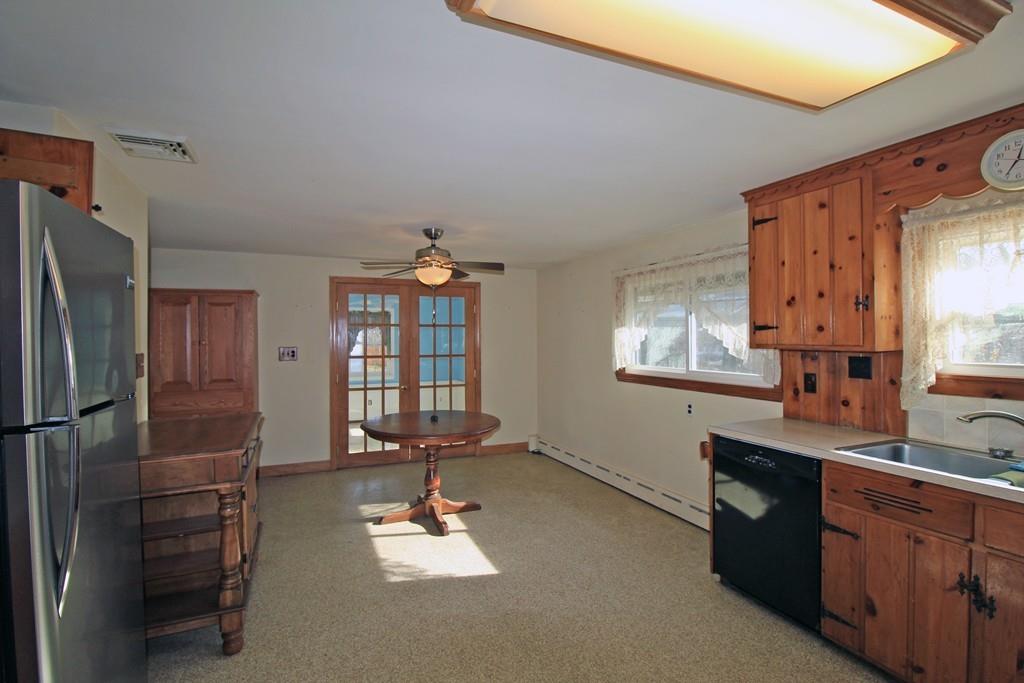 176 Columbia Road Lowell, MA 01854 - Photo 3 of 14 a kitchen with refrigerator cabinets and furniture
