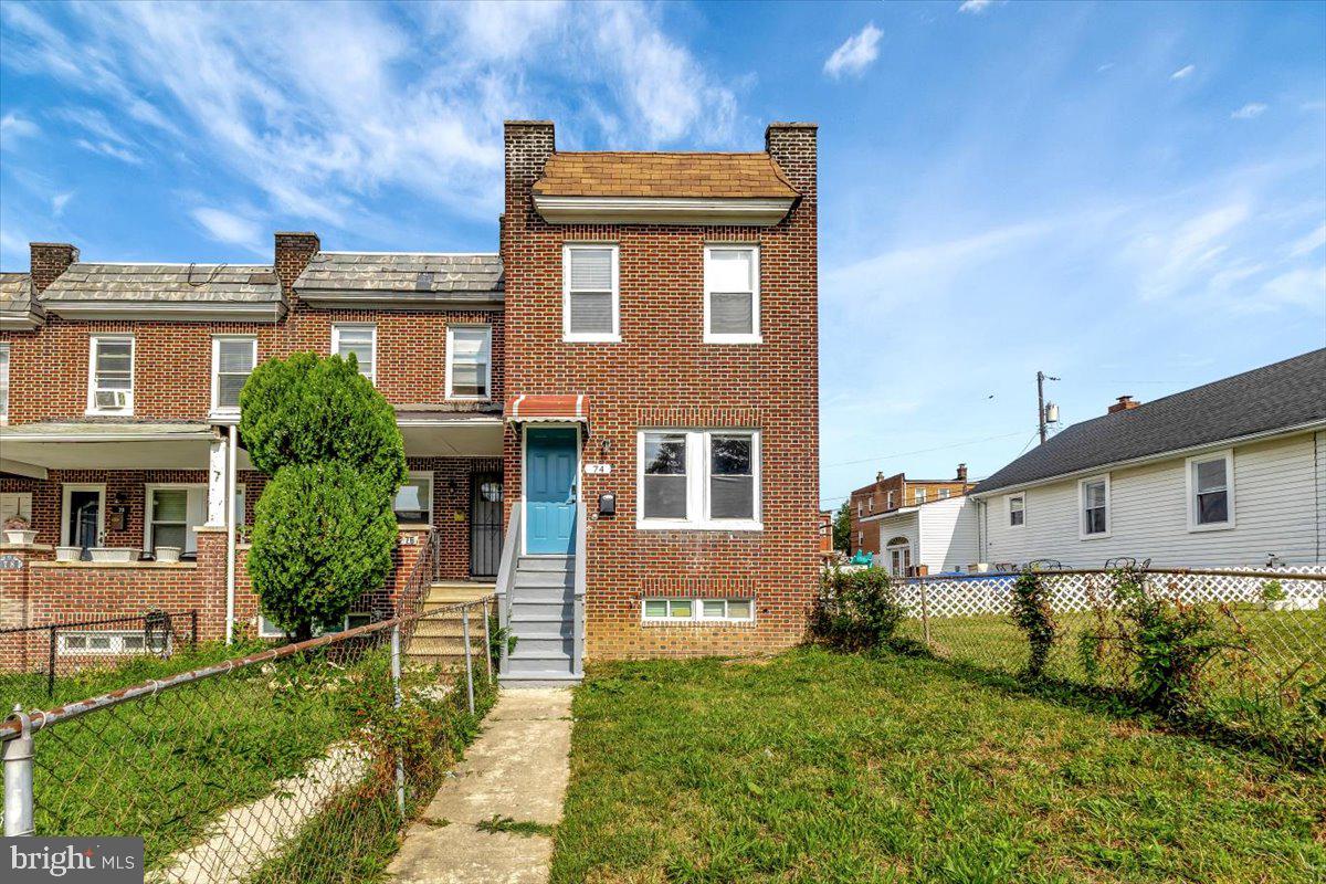 74 South Kossuth Street Baltimore, MD 21229 - Photo 1 of 18 a front view of a house with a yard