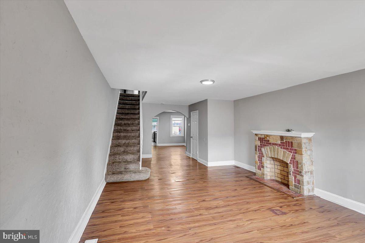 74 South Kossuth Street Baltimore, MD 21229 - Photo 12 of 18 a view of an empty room with wooden floor