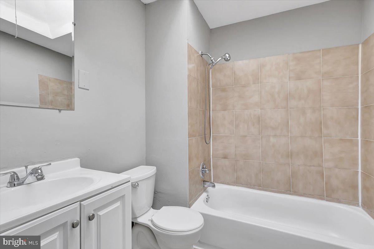 74 South Kossuth Street Baltimore, MD 21229 - Photo 2 of 18 a bathroom with a sink toilet and shower