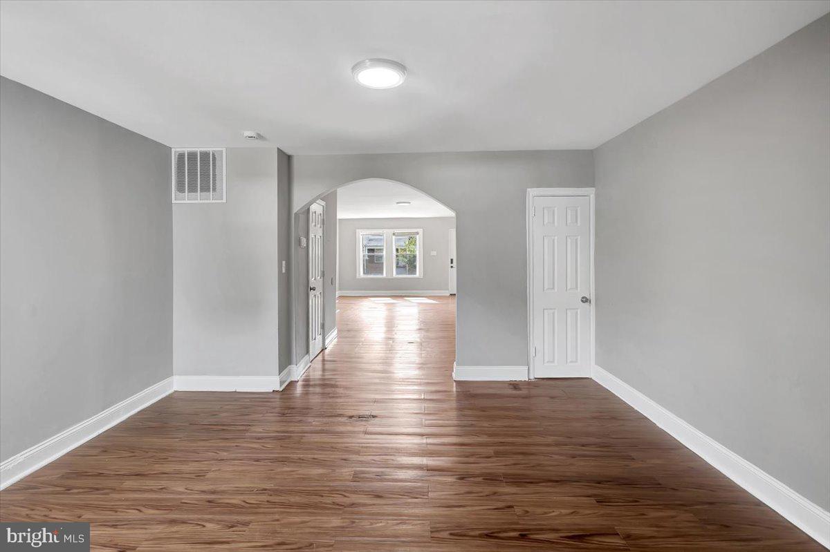 74 South Kossuth Street Baltimore, MD 21229 - Photo 8 of 18 a view of empty room with wooden floor