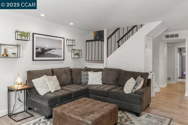 a living room with furniture and a painting