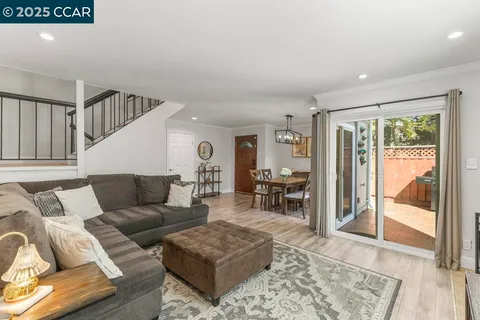 a living room with a fireplace and a flat screen tv