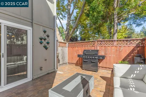 a kitchen with granite countertop a refrigerator and a stove top oven