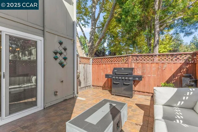 a kitchen with granite countertop a refrigerator and a stove top oven
