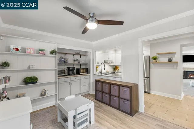 a view of a kitchen with a refrigerator and a sink