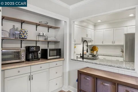 a view of a hallway with wooden floor and entryway