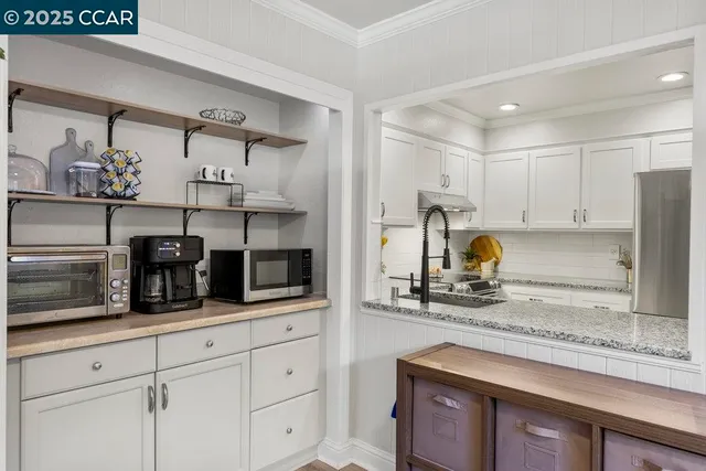 a view of a hallway with wooden floor and entryway