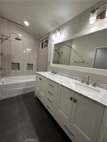 a bathroom with a granite countertop sink mirror and double