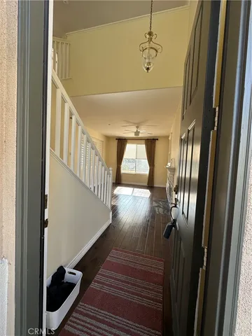 a view of entryway and hall with wooden floor