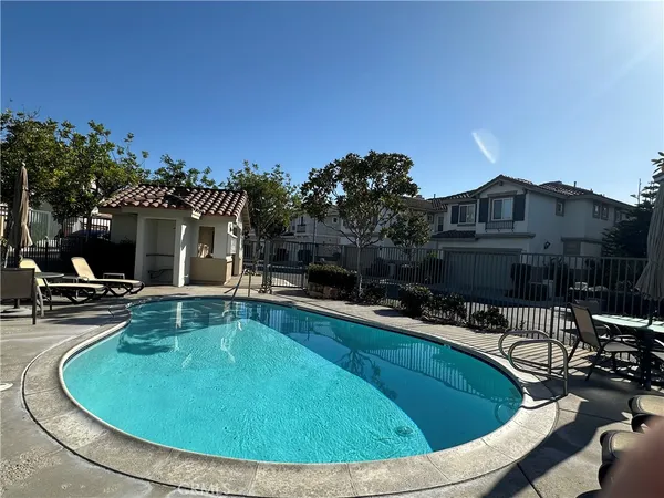 a view of a house with swimming pool and sitting area