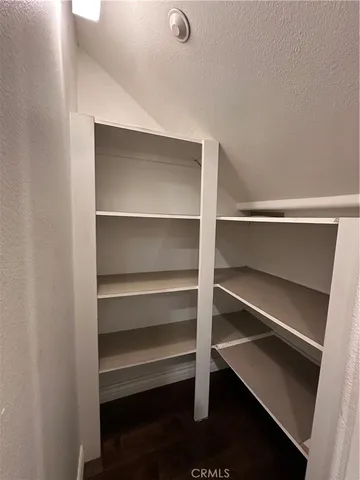 a view of walk in closet with empty racks