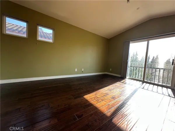 a view of a room with wooden floor and balcony
