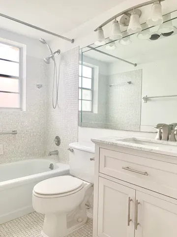 a bathroom with a sink a toilet and a bathtub