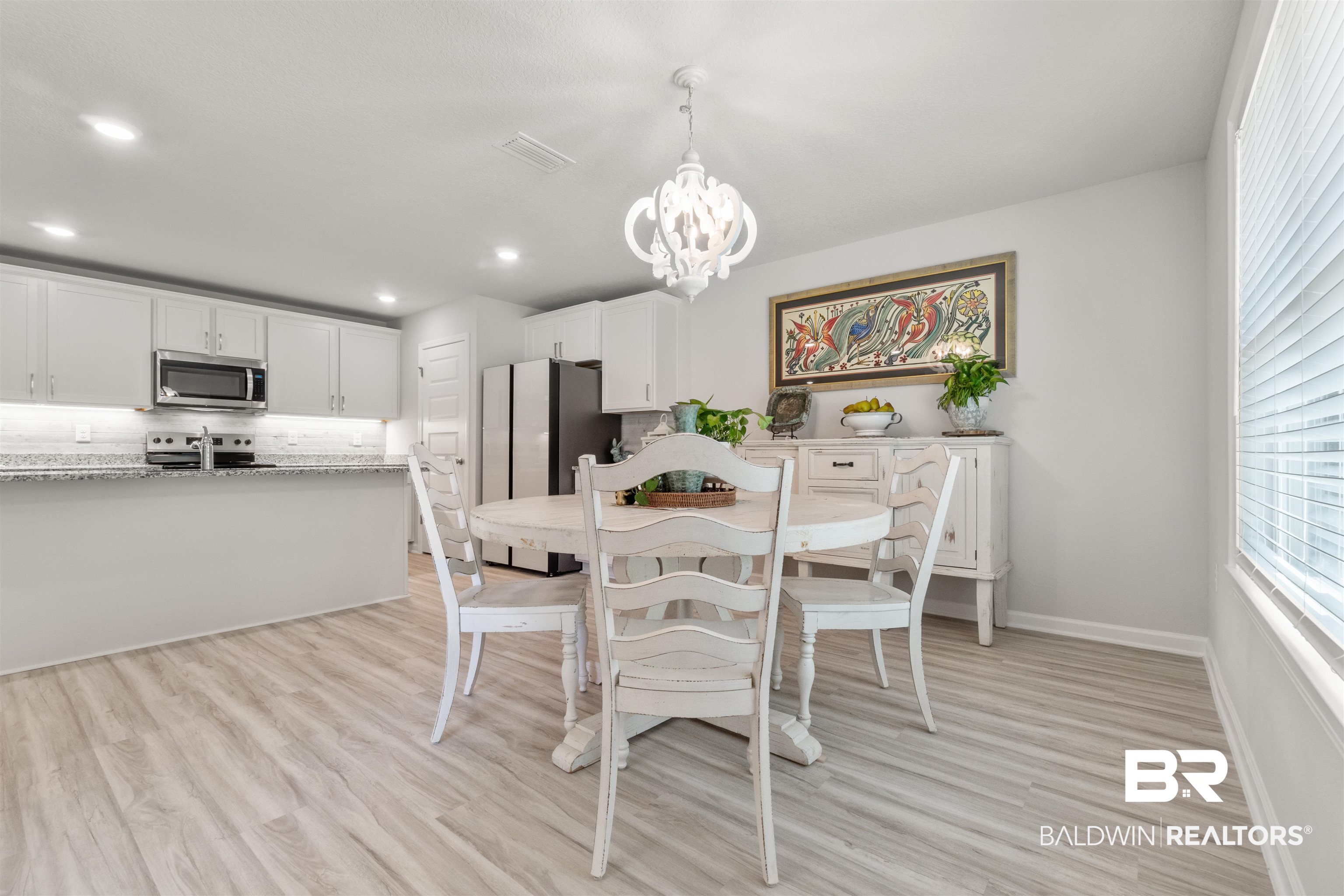 24472 Ringneck Loop Elberta, AL 36530 - Photo 13 of 46 Dining space featuring a notable chandelier and light hardwood / wood-style floors