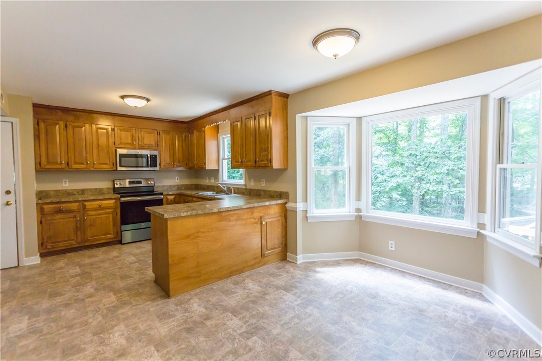 5111 Rock Harbour Road Midlothian, VA 23112 - Photo 17 of 50 a kitchen with granite countertop a stove a sink and a refrigerator