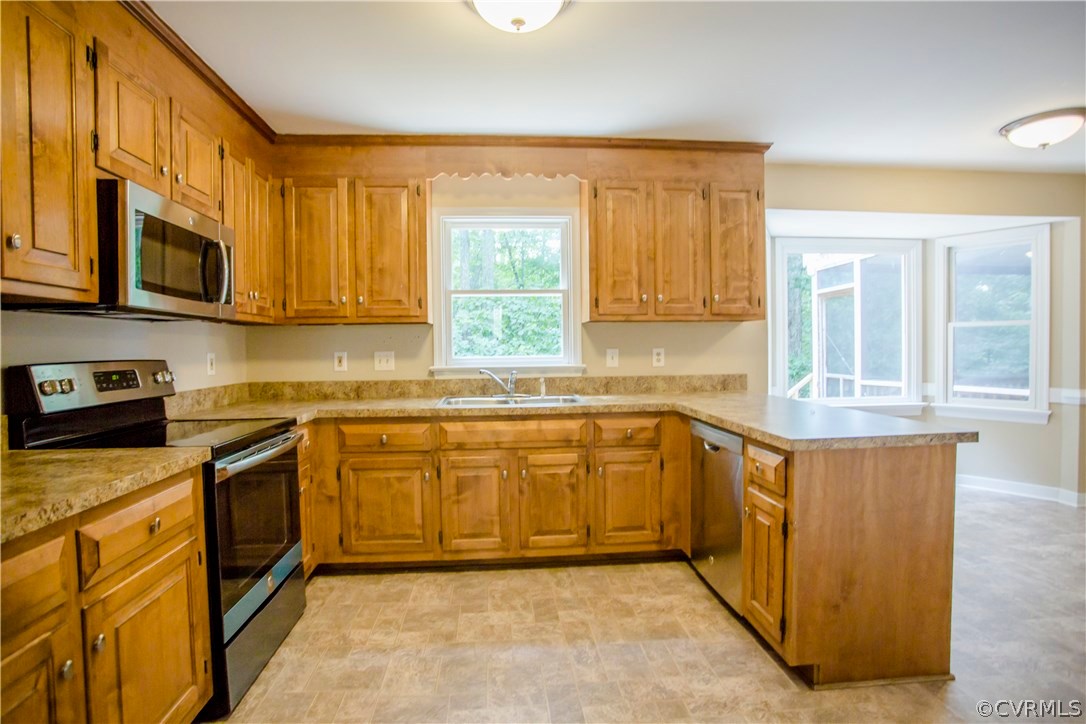 5111 Rock Harbour Road Midlothian, VA 23112 - Photo 20 of 50 a kitchen with stainless steel appliances granite countertop a stove a sink and a microwave