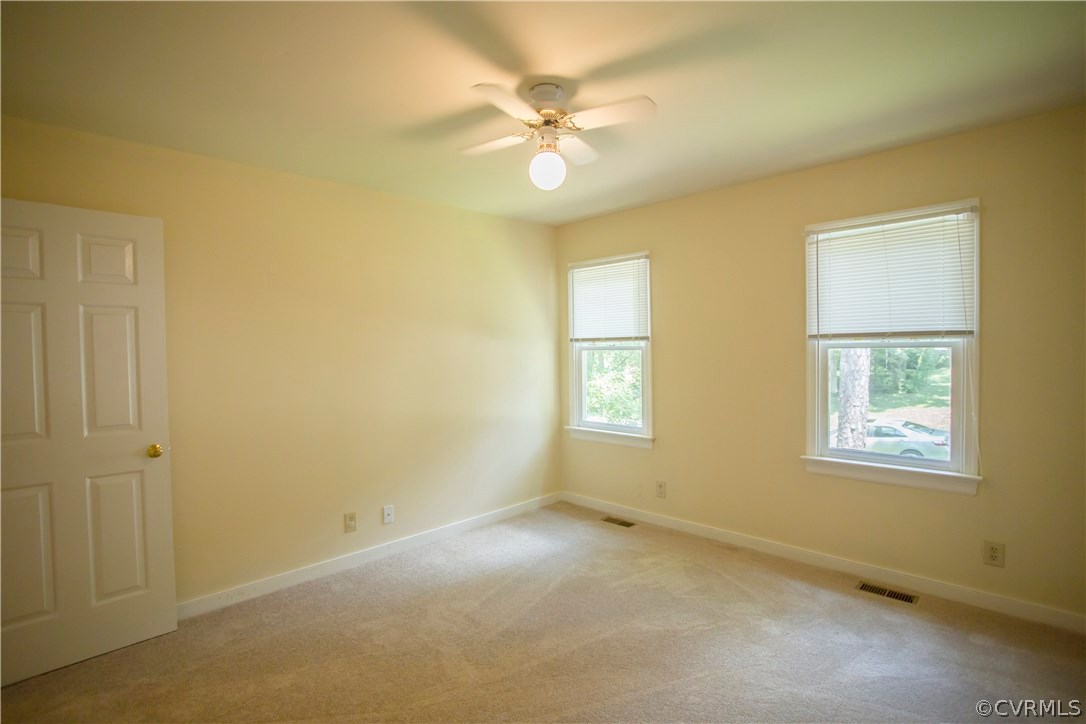 5111 Rock Harbour Road Midlothian, VA 23112 - Photo 31 of 50 an empty room with windows and fan
