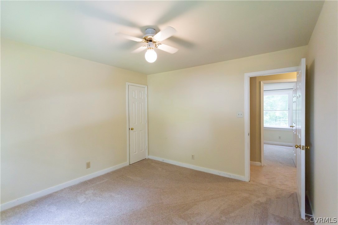 5111 Rock Harbour Road Midlothian, VA 23112 - Photo 33 of 50 an empty room with a chandelier fan and a bathroom
