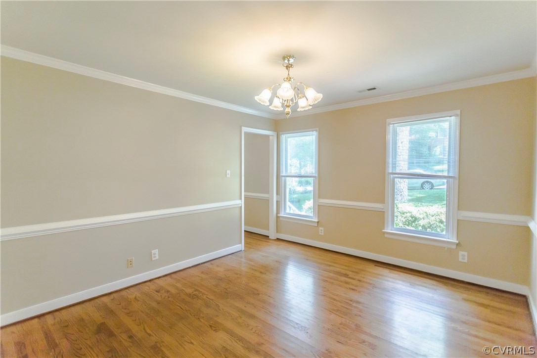 5111 Rock Harbour Road Midlothian, VA 23112 - Photo 10 of 50 an empty room with wooden floor chandelier and windows