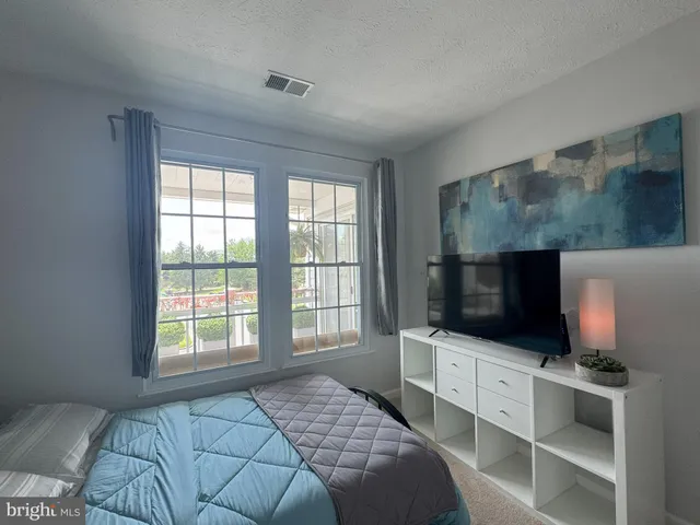 a bedroom with a television and a bed