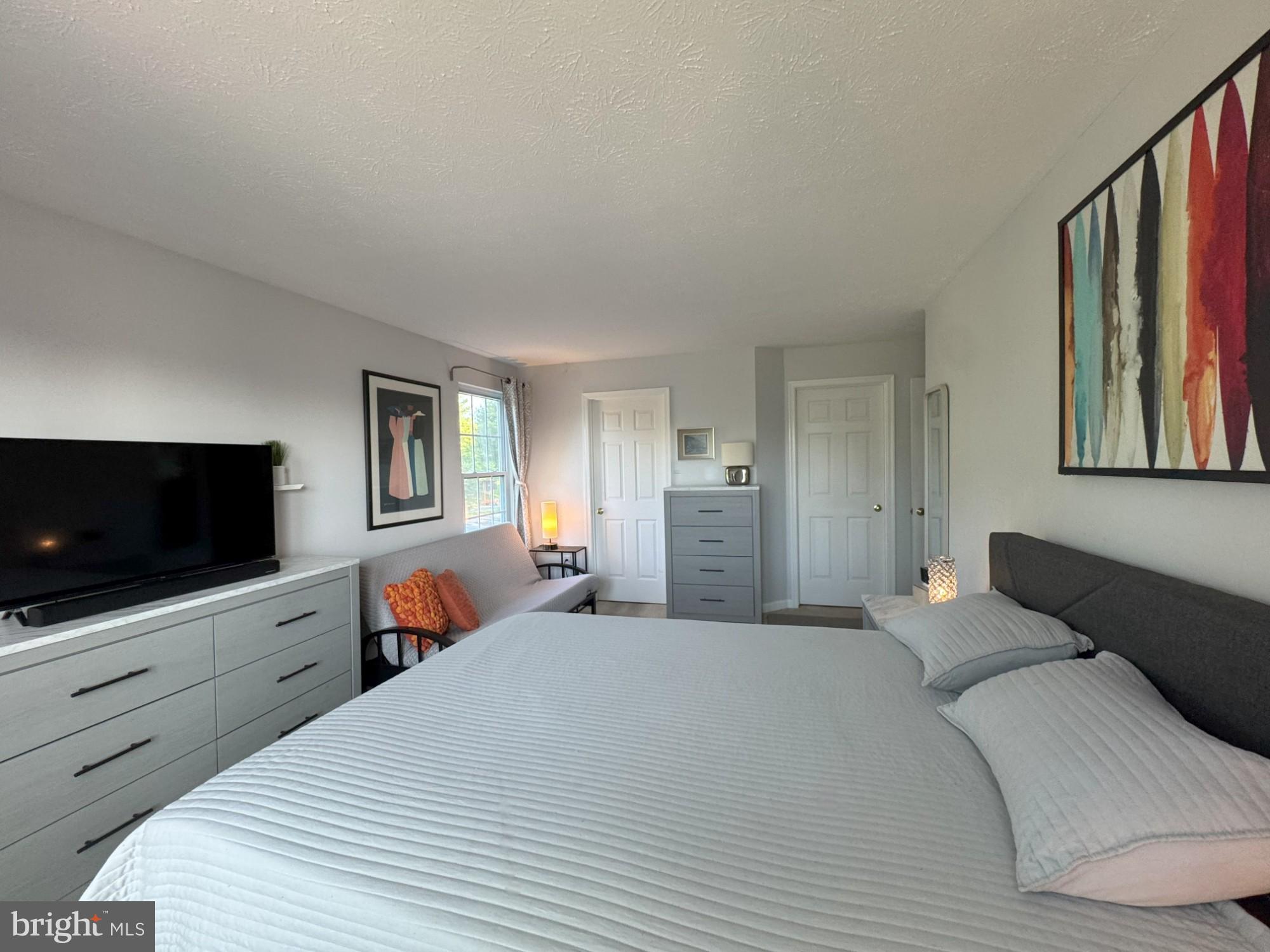 1601 Berry Rose Court, Unit 4 3J Frederick, MD 21701 - Photo 14 of 17 a bedroom with a bed and a flat screen tv