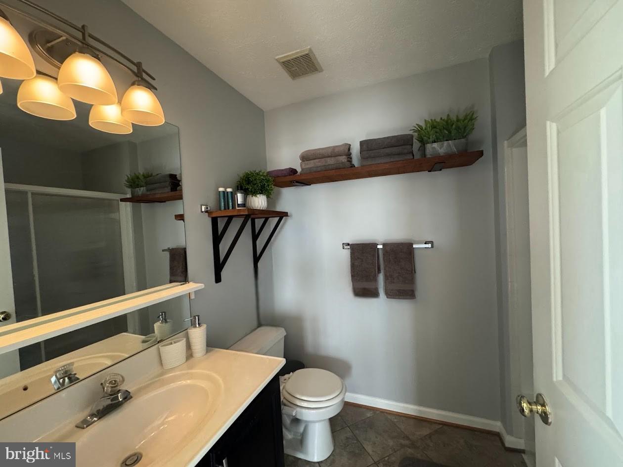 1601 Berry Rose Court, Unit 4 3J Frederick, MD 21701 - Photo 15 of 17 a bathroom with a sink toilet and shower