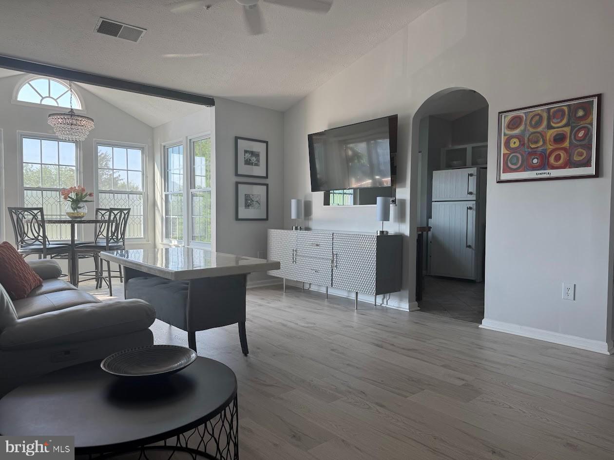 1601 Berry Rose Court, Unit 4 3J Frederick, MD 21701 - Photo 2 of 17 a living room with furniture and a dining table with wooden floor
