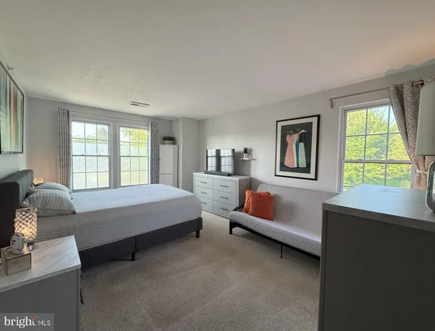 a bedroom with furniture and a window