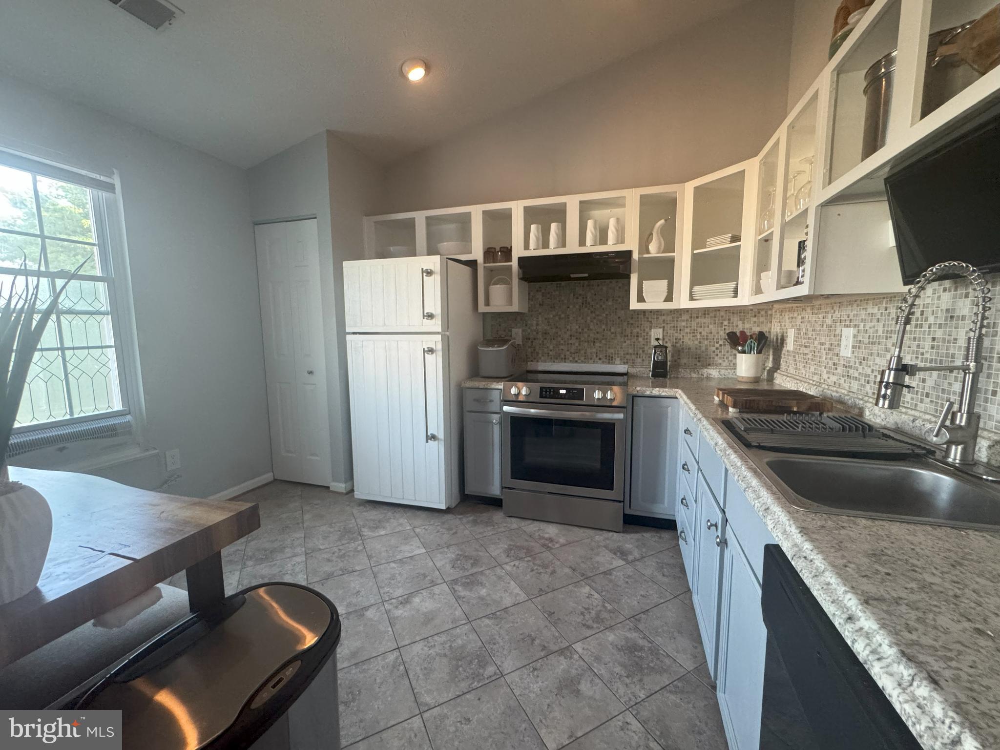 1601 Berry Rose Court, Unit 4 3J Frederick, MD 21701 - Photo 8 of 17 a kitchen with kitchen island granite countertop a sink cabinets and stainless steel appliances