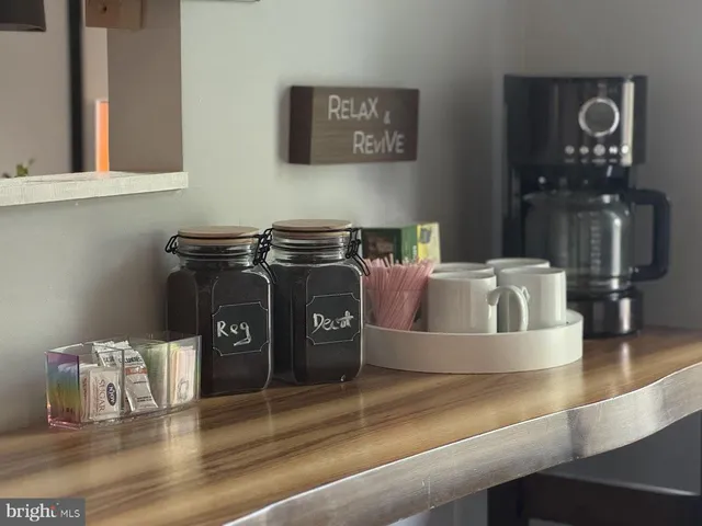 a kitchen with a stove and a wooden floor