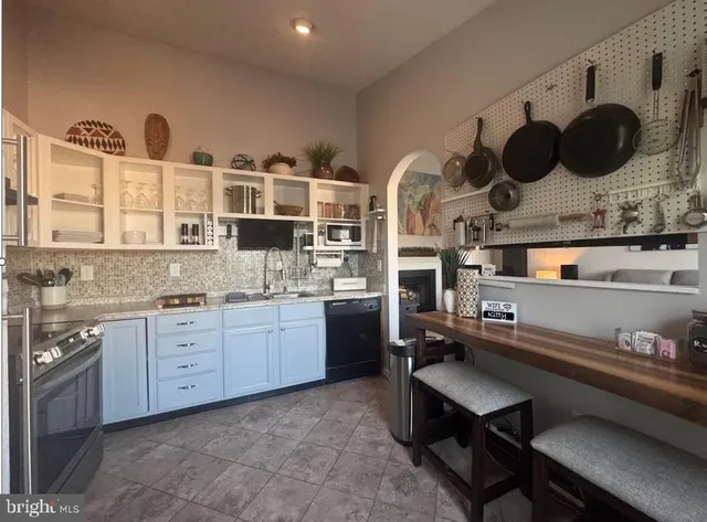 a kitchen with granite countertop a sink and a stove with wooden floor