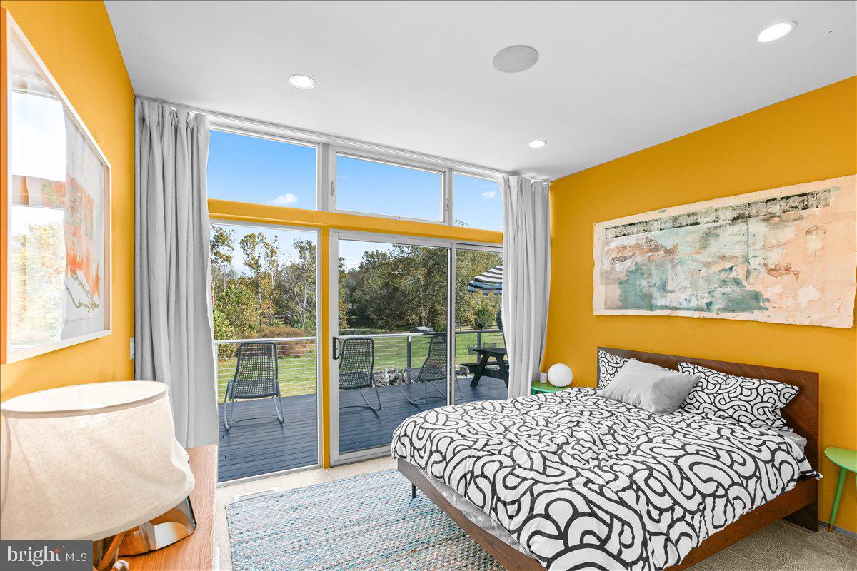10222 Van Thompson Road Fairfax Station, VA 22039 - Photo 13 of 37 a bedroom with a bed and a large window with outer view