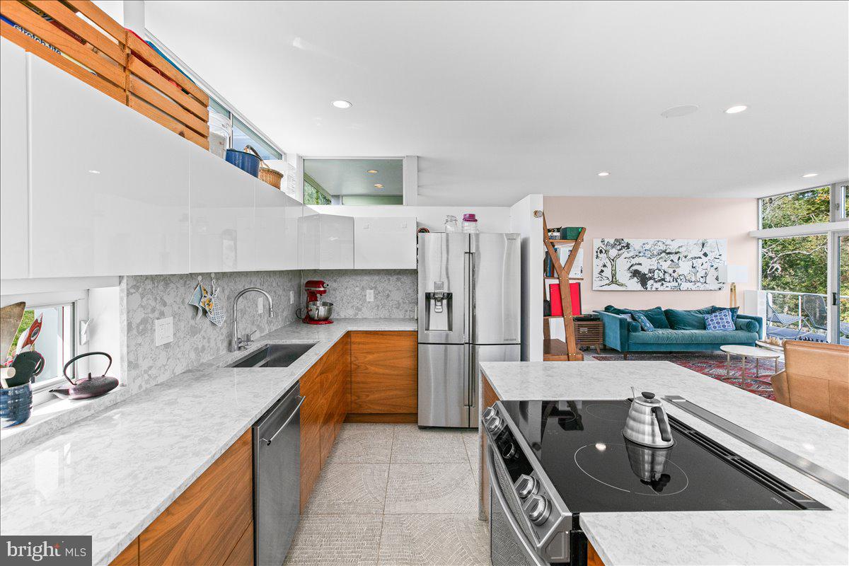 10222 Van Thompson Road Fairfax Station, VA 22039 - Photo 10 of 37 a kitchen with stainless steel appliances granite countertop a sink and a refrigerator