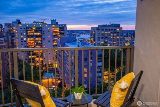 a view of a balcony with chairs and potted plants