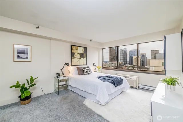 a bedroom with a bed couch and window