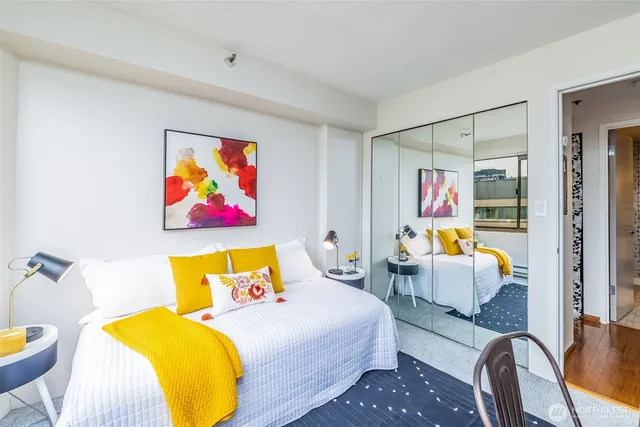 a bedroom with a bed and wooden floor