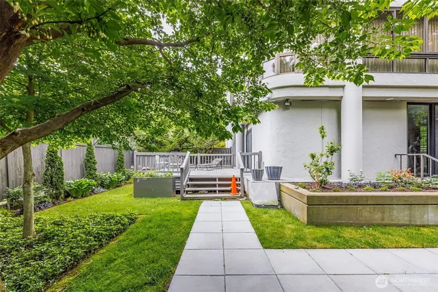 a view of house with backyard outdoor seating and green space