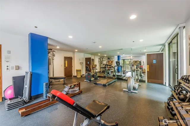 a room with gym equipment and a table