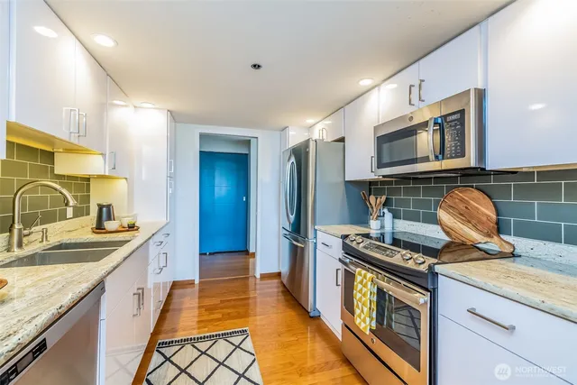 a kitchen that has a sink and a stove