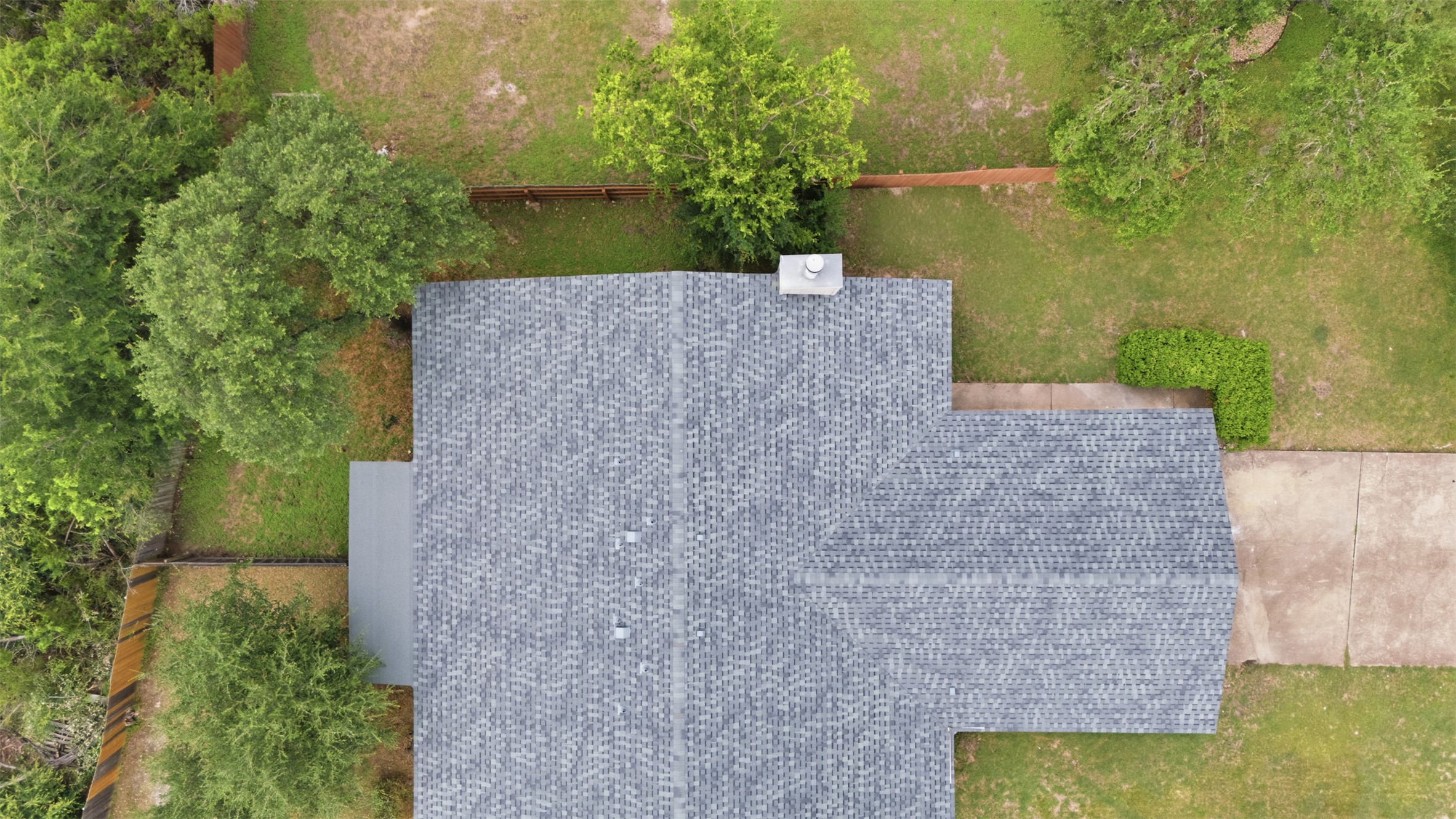 11611 Rustic Rock Drive, Unit B Austin, TX 78750 - Photo 27 of 30 An aerial perspective reveals the well-maintained shingle roof and surrounding green landscape.