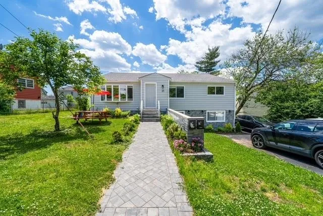 a front view of house with yard and green space