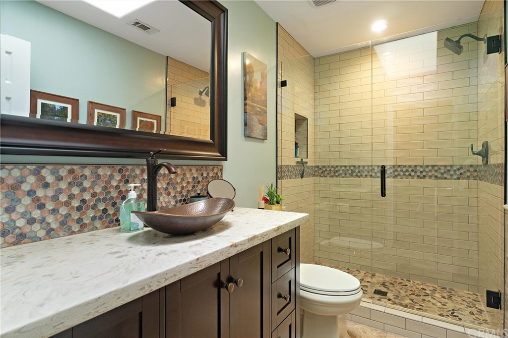 1833 Southfork Place Paso Robles, CA 93446 - Photo 18 of 35 a bathroom with a granite countertop sink a toilet a mirror and shower