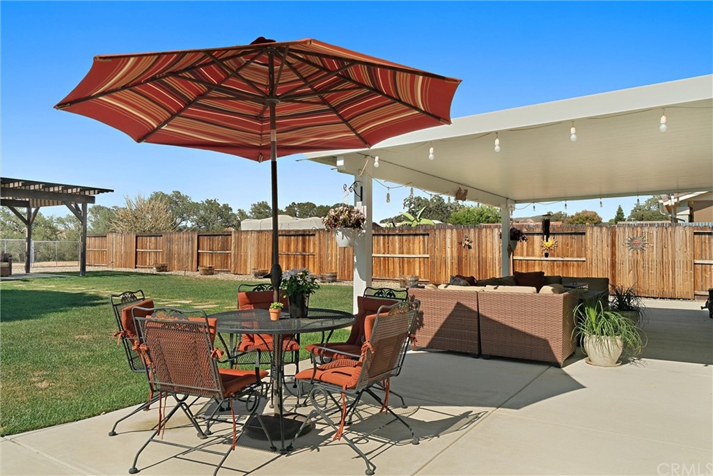 1833 Southfork Place Paso Robles, CA 93446 - Photo 26 of 35 a patio with a table and chairs under an umbrella