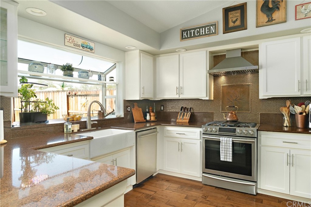 1833 Southfork Place Paso Robles, CA 93446 - Photo 9 of 35 a kitchen with stainless steel appliances granite countertop a stove a sink and white cabinets